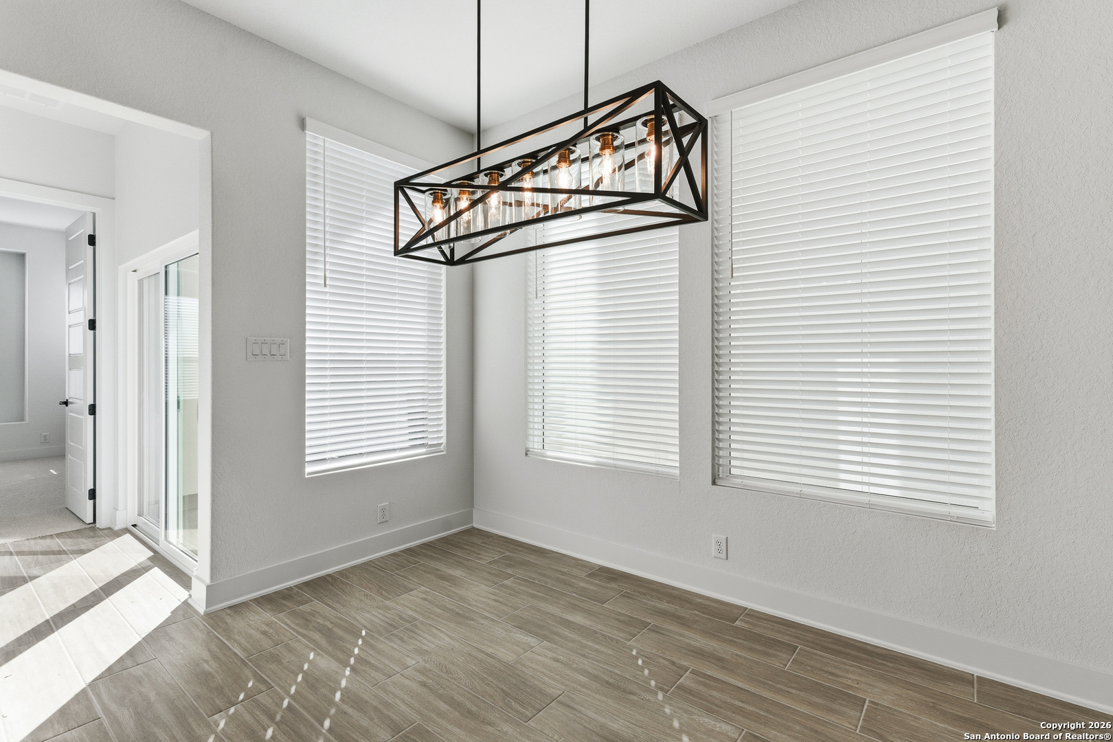 20675 Huebner Road, Unit 527 San Antonio, TX 78258 - Photo 19 of 43 an empty room with wooden floor and windows