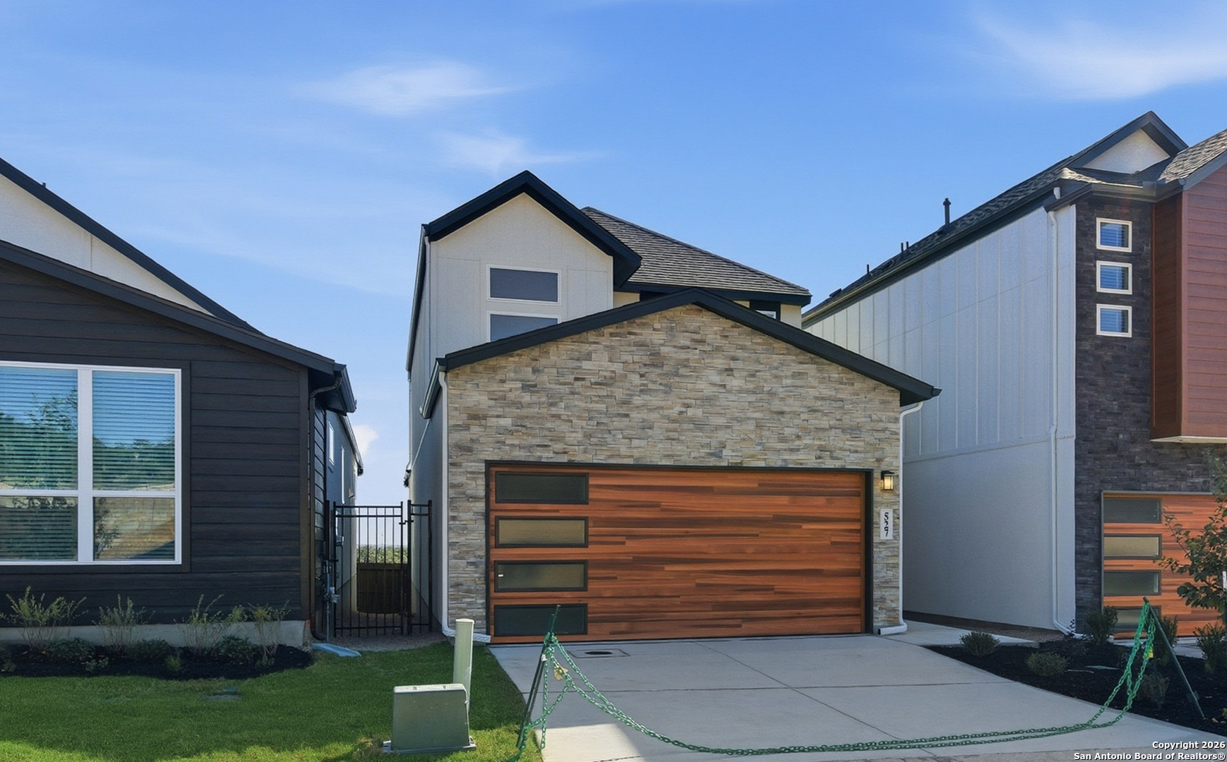 20675 Huebner Road, Unit 527 San Antonio, TX 78258 - Photo 2 of 43 a front view of a house with a yard