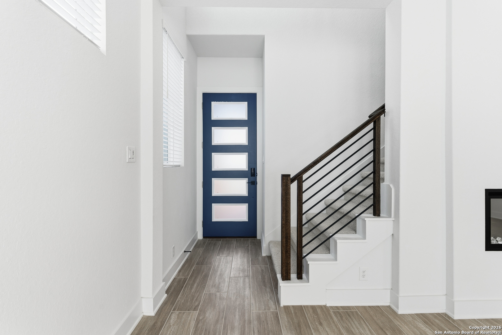 20675 Huebner Road, Unit 527 San Antonio, TX 78258 - Photo 7 of 43 a view of a hallway with wooden floor and staircase