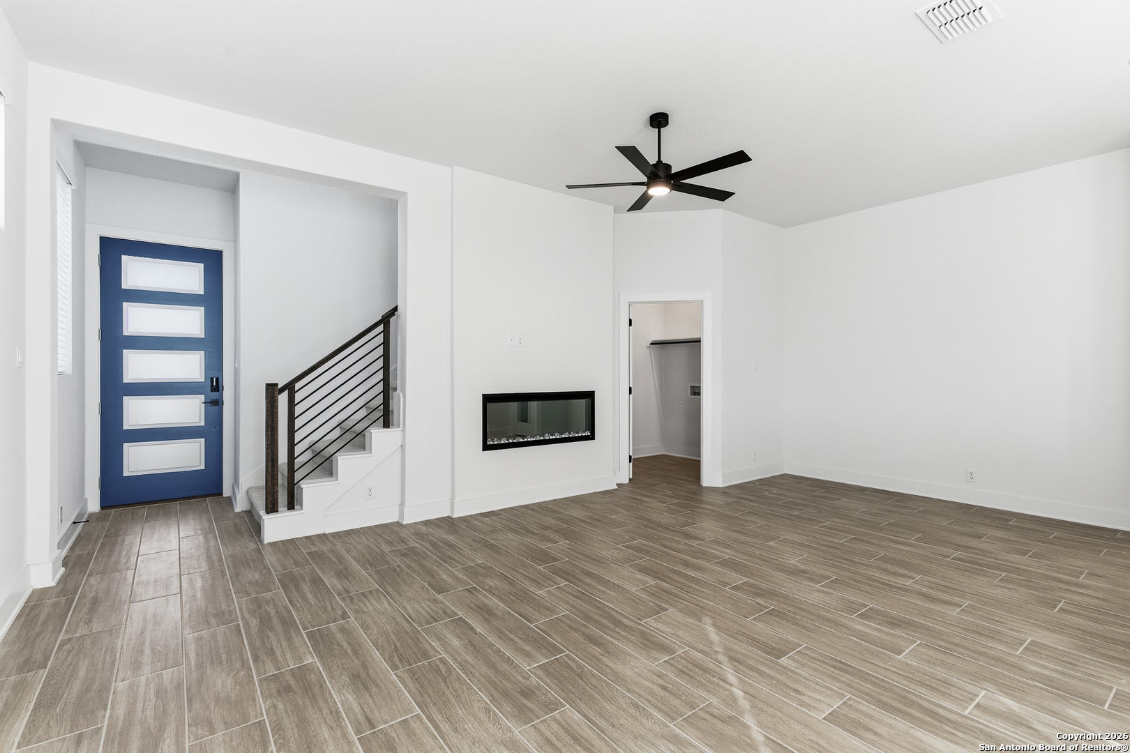 20675 Huebner Road, Unit 527 San Antonio, TX 78258 - Photo 8 of 43 a view of empty room with wooden floor and ceiling fan