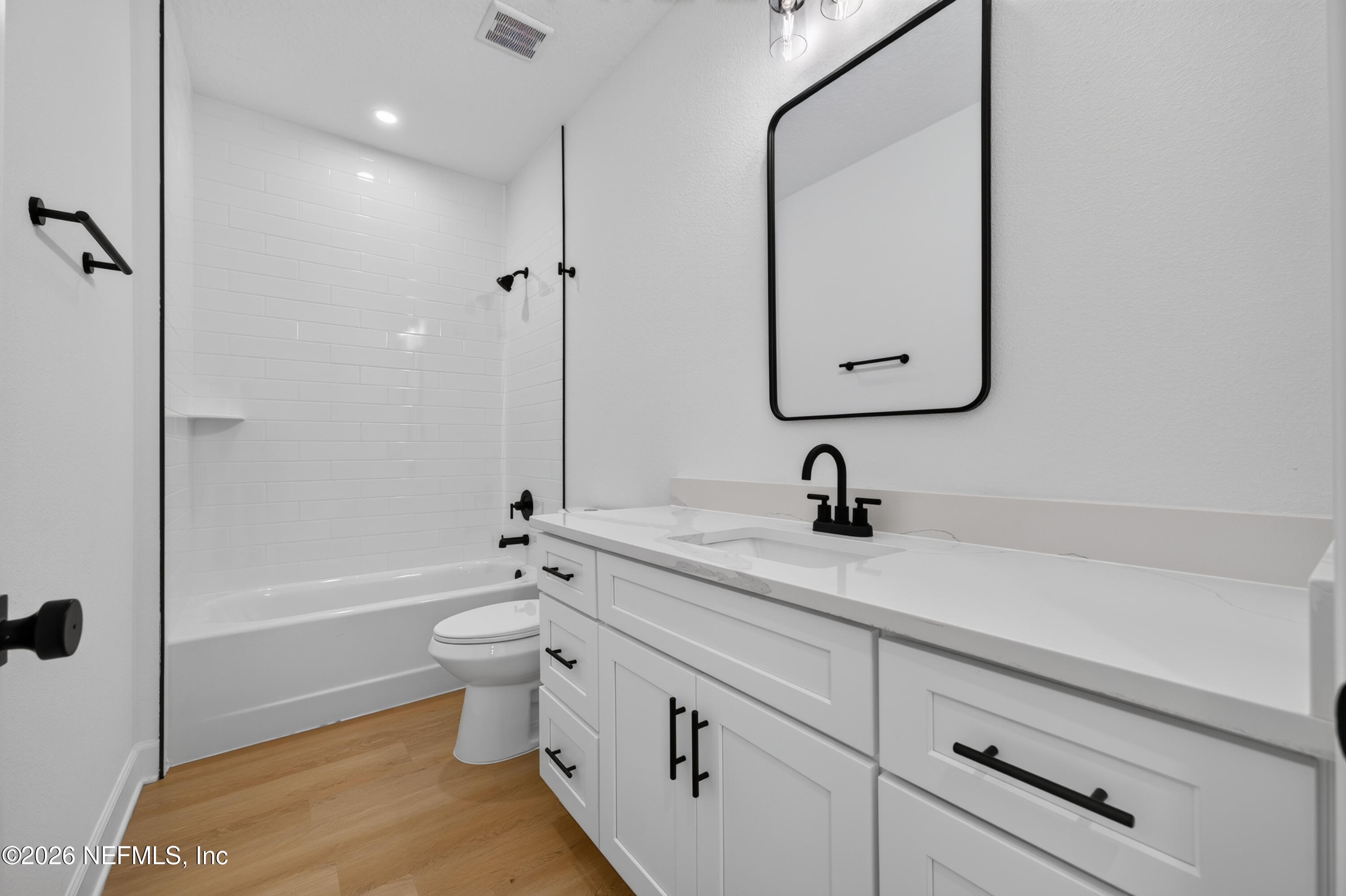 4362 Angora Street Middleburg, FL 32068 - Photo 20 of 31 a en suite bathroom with a granite countertop toilet a sink and a bathtub