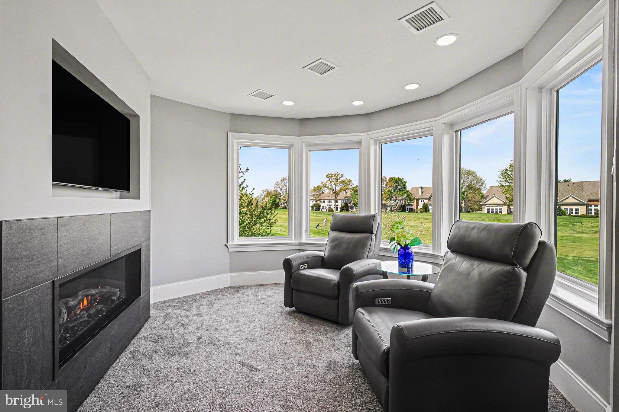 671 Bent Creek Drive Lititz, PA 17543 - Photo 27 of 61 a living room with furniture a flat screen tv and a fireplace