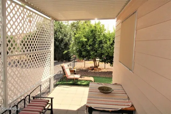 a view of a chair and tables back yard of the house