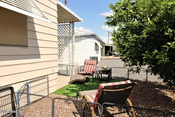 a view of backyard with outdoor seating and plants