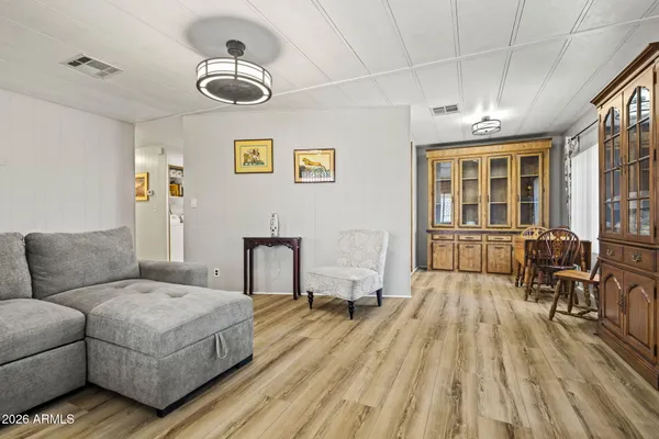 a living room with furniture and a wooden floor