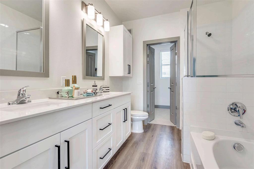4020 McEwen Road, Unit 9123 Farmers Branch, TX 75244 - Photo 4 of 20 Bathroom with a bathtub, double vanity, light wood-style floors, and a tile shower