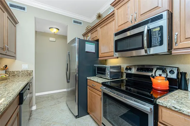 a kitchen with stainless steel appliances granite countertop a stove and a microwave