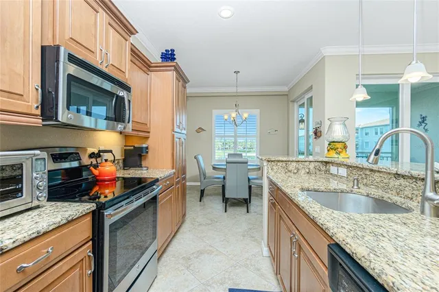 a kitchen with stainless steel appliances granite countertop a sink and stove
