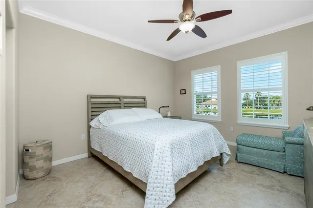 a bedroom with a bed and ceiling fan