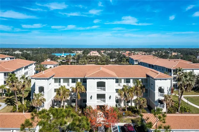 an aerial view of multiple houses with a yard