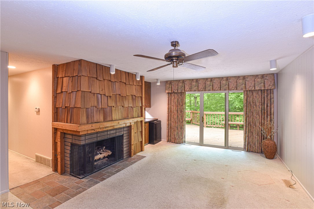 17612 Ridge Creek Road Strongsville, OH 44136 - Photo 12 of 31 The family room has a gas fireplace and access to the deck.