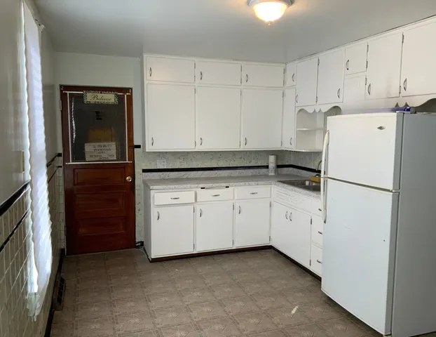 a kitchen with cabinets appliances and a sink