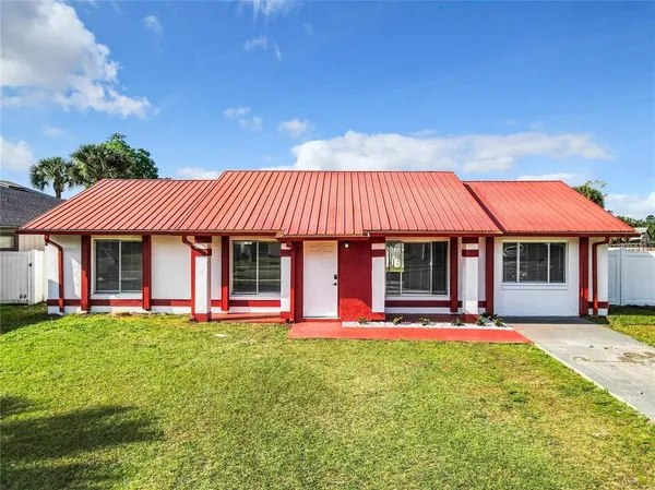 a view of a house with a yard patio and a fire pit
