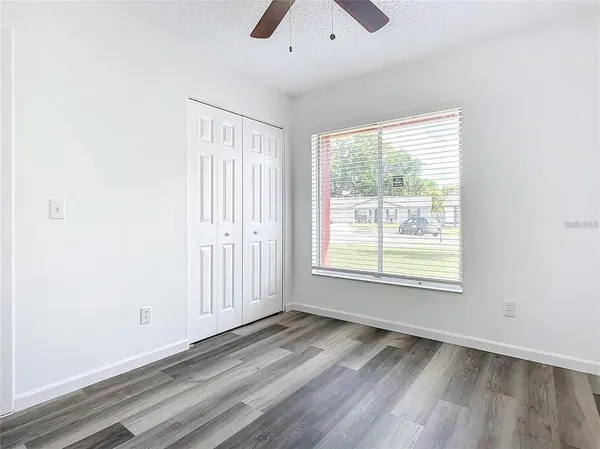 a view of empty room with ceiling fan