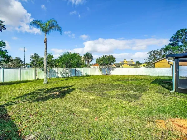 a view of a house with a backyard