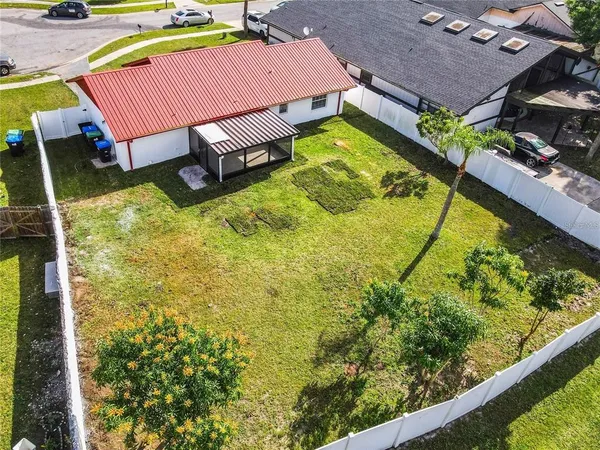 an aerial view of a house with a swimming pool outdoor seating and yard