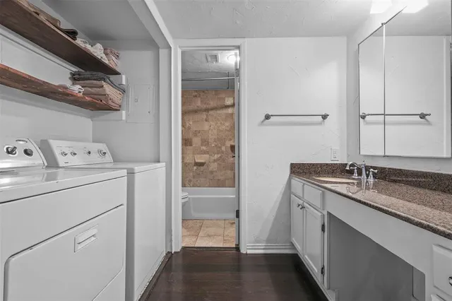 a bathroom with a granite countertop sink a vanity and a shower