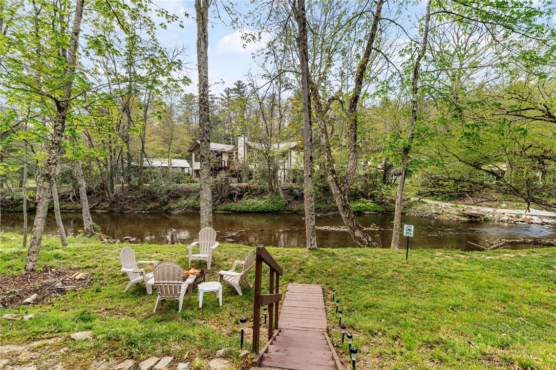 139 Golden Rod Loop Newland, NC 28657 - Photo 35 of 39 a backyard of a house with lots of green space and lake view