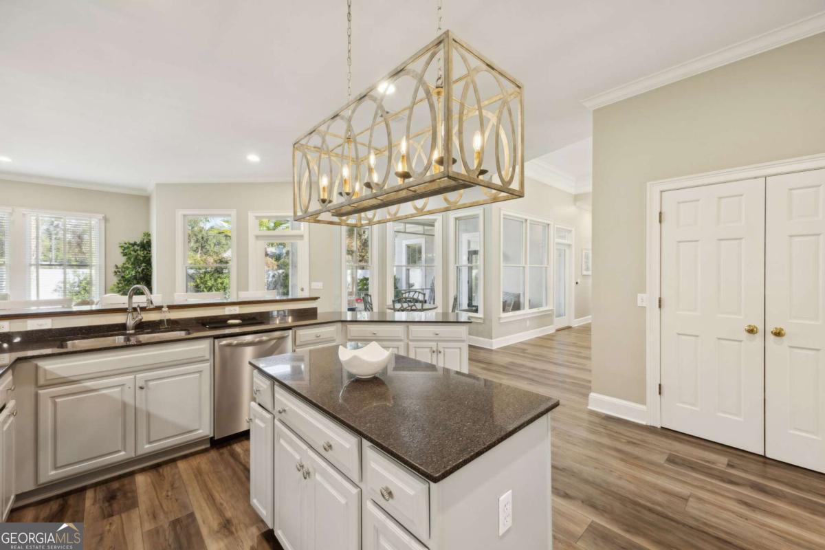 343 Major Wright Road St. Simons, GA 31522 - Photo 13 of 53 a kitchen with stainless steel appliances granite countertop a sink and dishwasher a stove with wooden floor