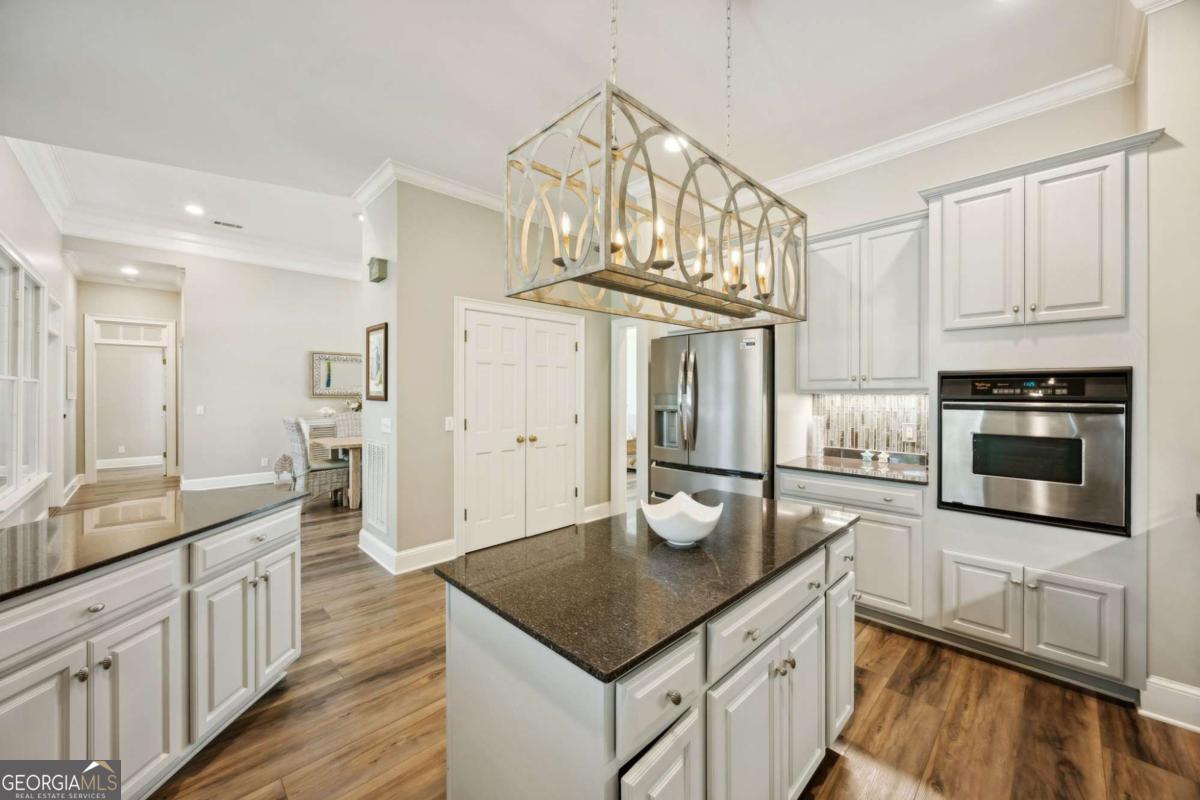 343 Major Wright Road St. Simons, GA 31522 - Photo 14 of 53 a kitchen with cabinets and wooden floor
