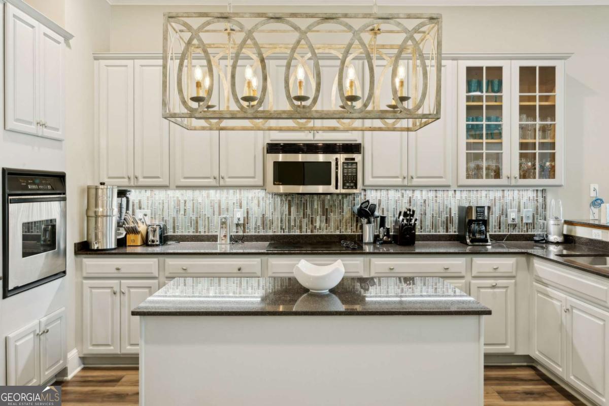 343 Major Wright Road St. Simons, GA 31522 - Photo 15 of 53 a kitchen with stainless steel appliances granite countertop a sink and cabinets