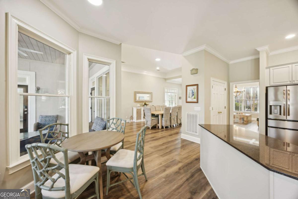 343 Major Wright Road St. Simons, GA 31522 - Photo 16 of 53 a dining room with furniture and wooden floor