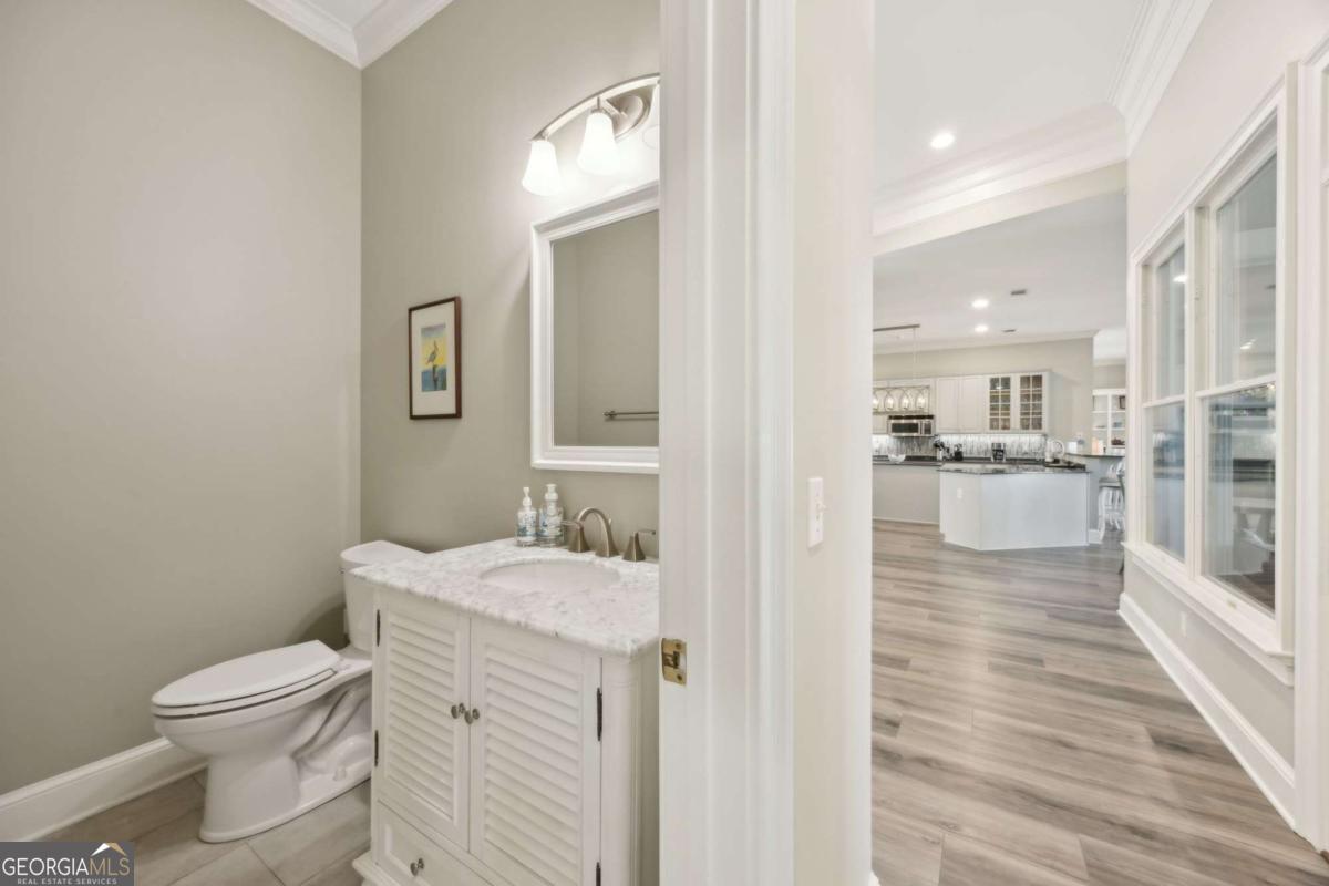 343 Major Wright Road St. Simons, GA 31522 - Photo 18 of 53 a bathroom with a sink a toilet a mirror and vanity