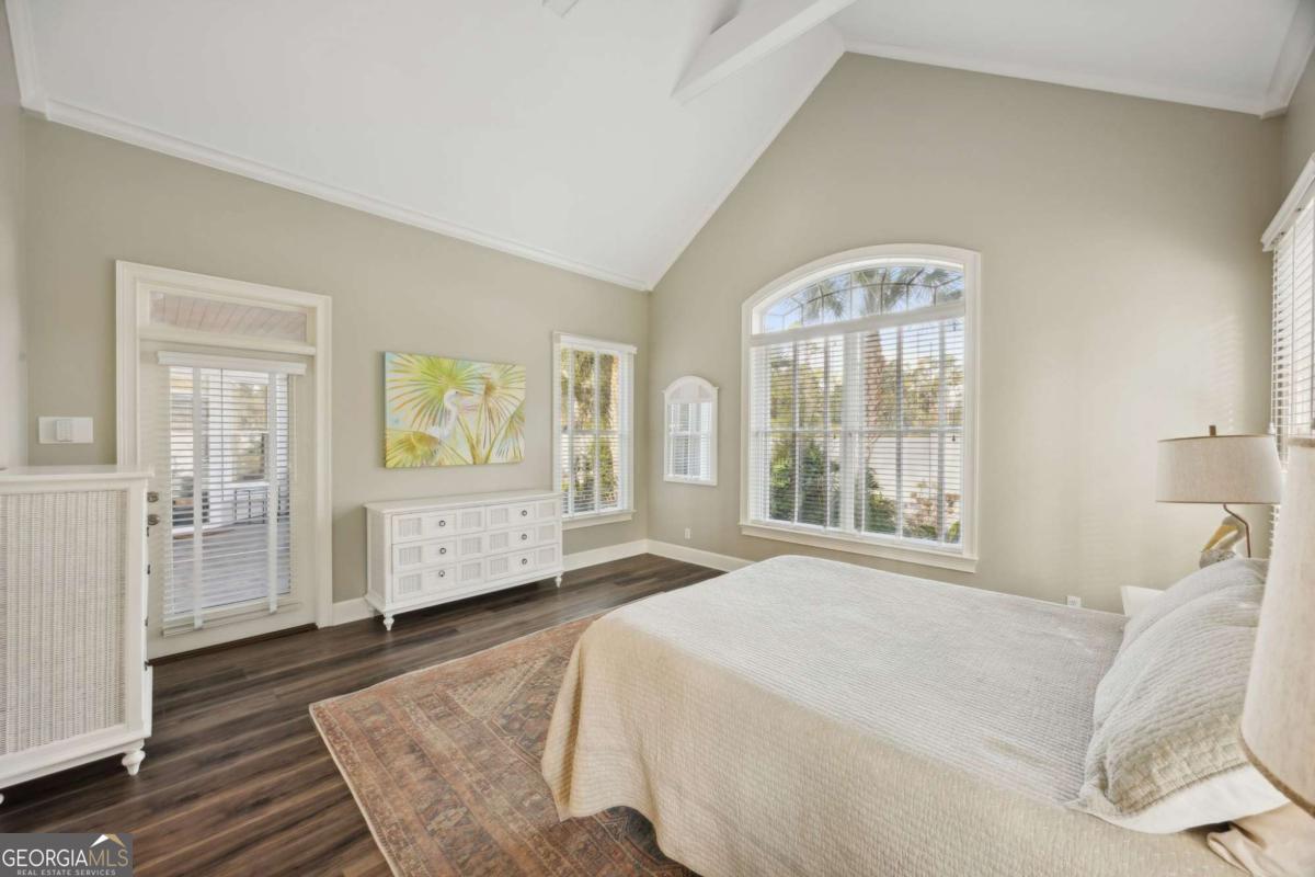 343 Major Wright Road St. Simons, GA 31522 - Photo 21 of 53 a spacious bedroom with a bed a couch and large window