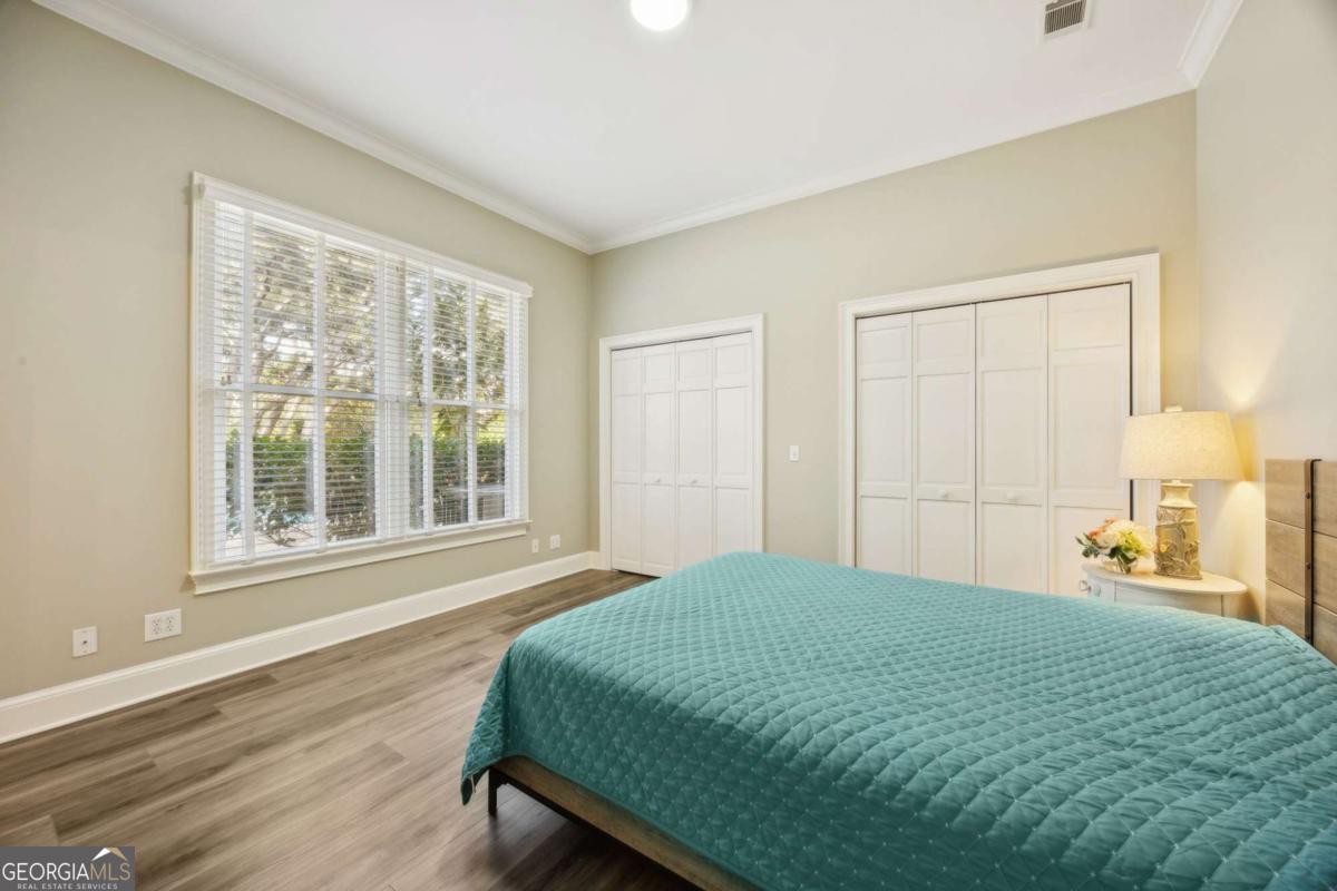 343 Major Wright Road St. Simons, GA 31522 - Photo 25 of 53 a bedroom with a bed and a window