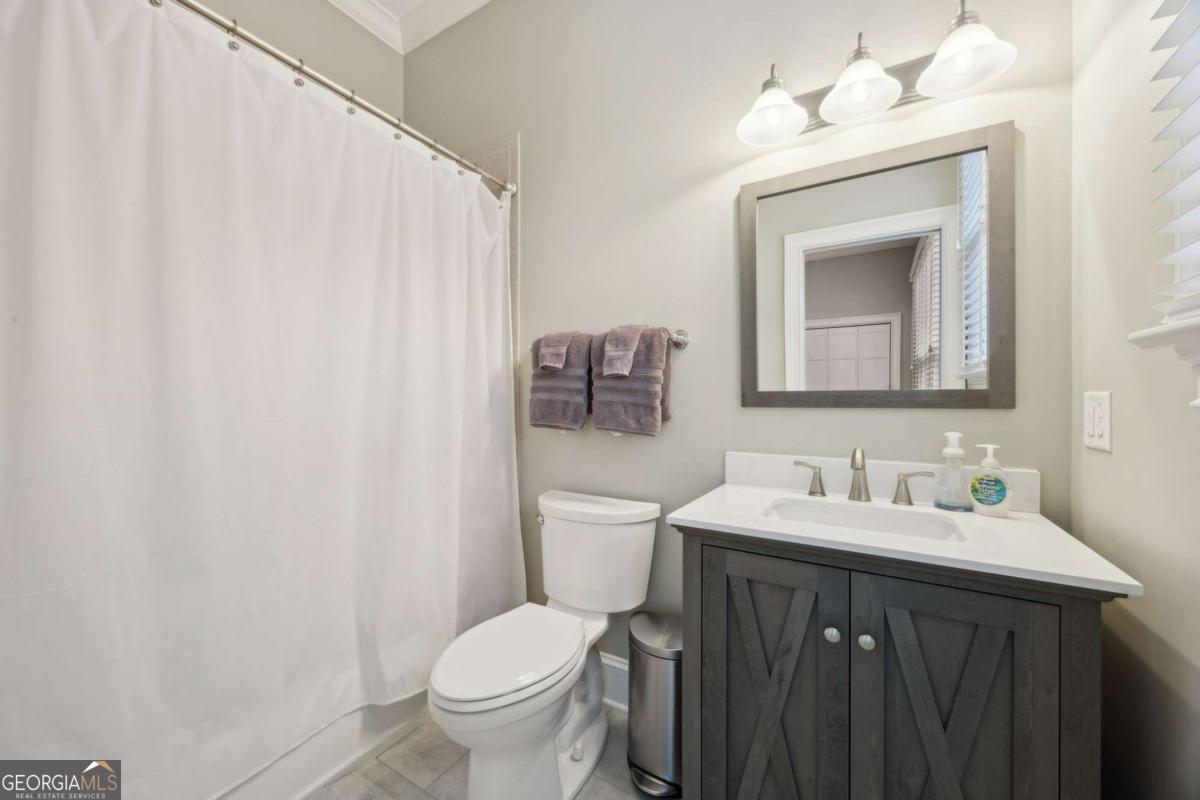 343 Major Wright Road St. Simons, GA 31522 - Photo 27 of 53 a bathroom with a toilet sink and mirror