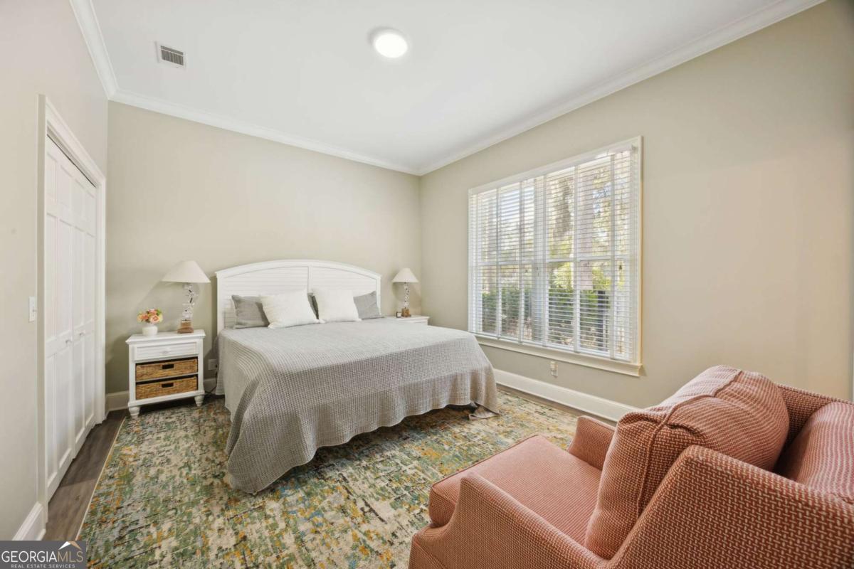 343 Major Wright Road St. Simons, GA 31522 - Photo 28 of 53 a bedroom with bed couch and window