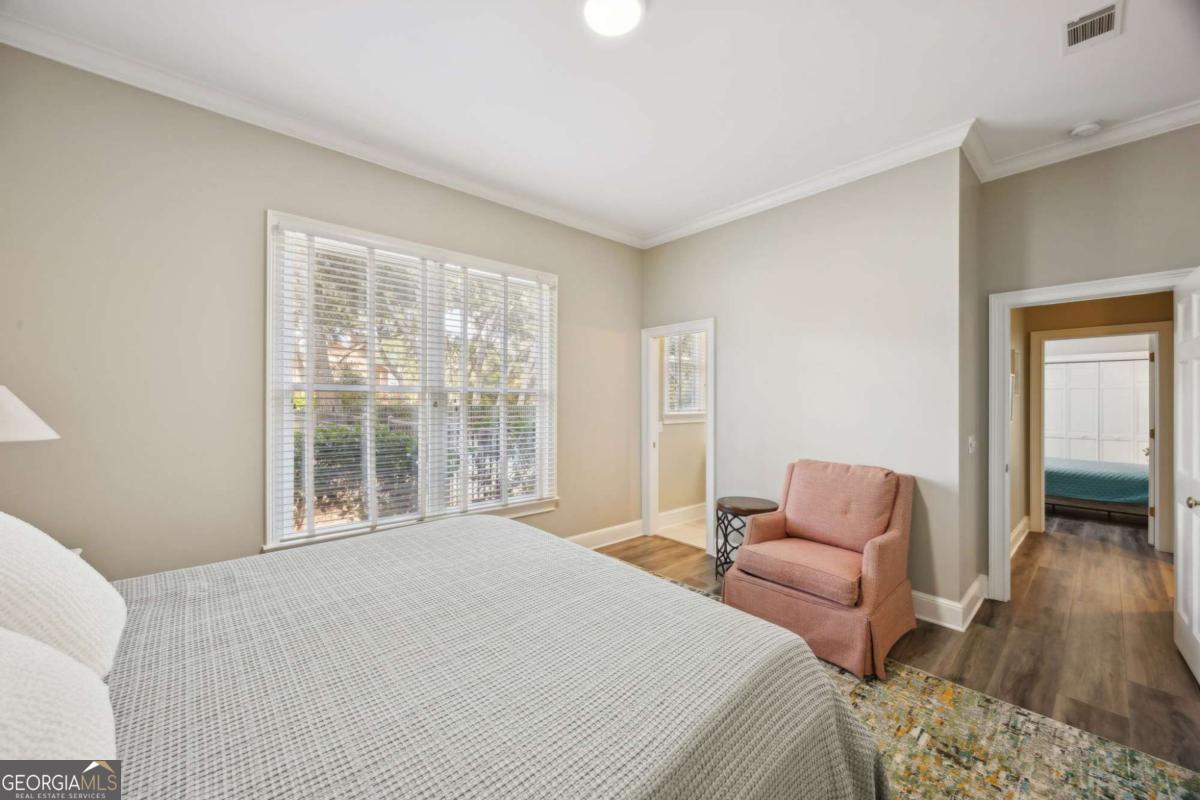 343 Major Wright Road St. Simons, GA 31522 - Photo 29 of 53 a bedroom with furniture and a window