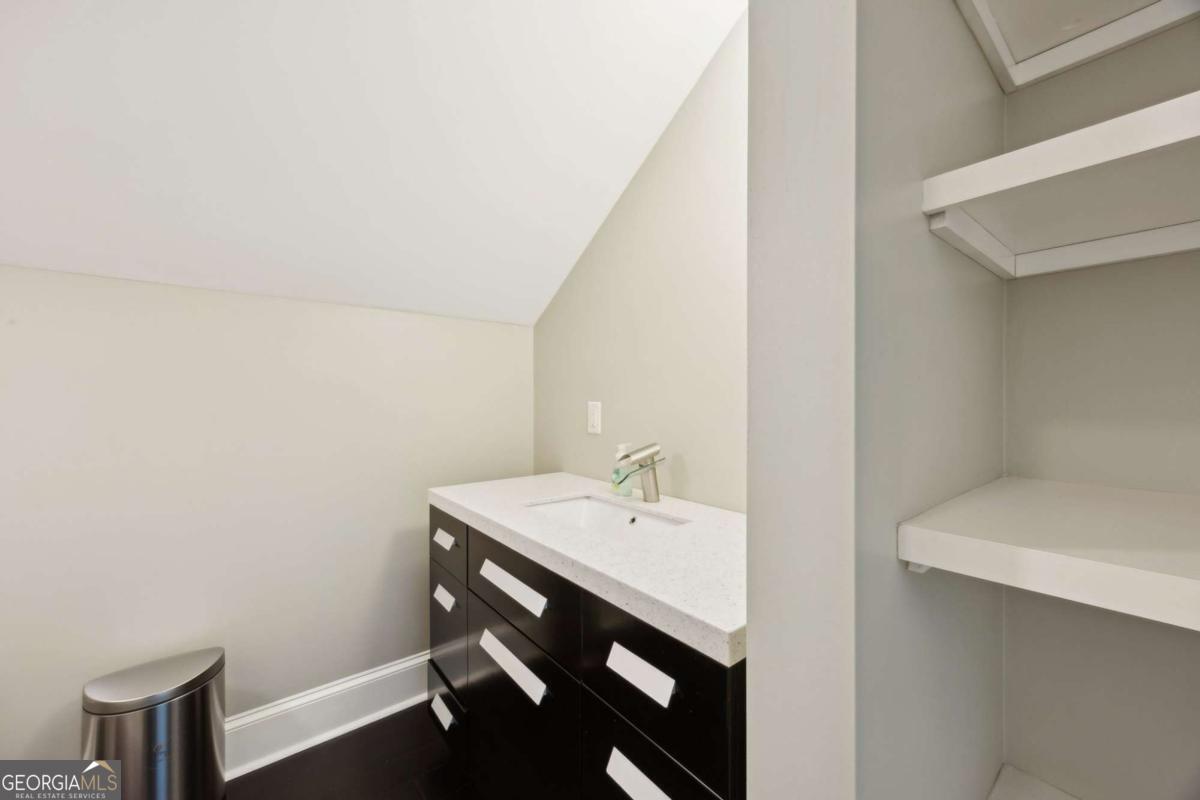 343 Major Wright Road St. Simons, GA 31522 - Photo 32 of 53 a bathroom with a sink and a mirror