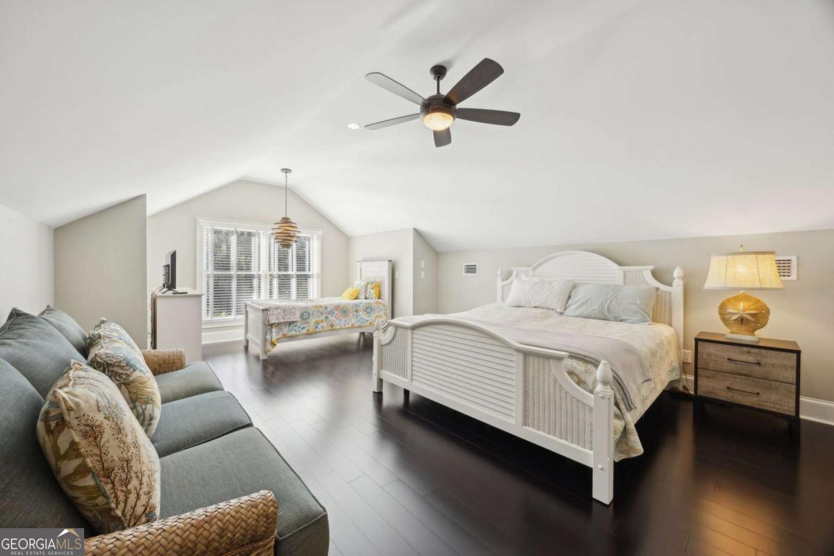 343 Major Wright Road St. Simons, GA 31522 - Photo 33 of 53 a bedroom with a bed couch and a window