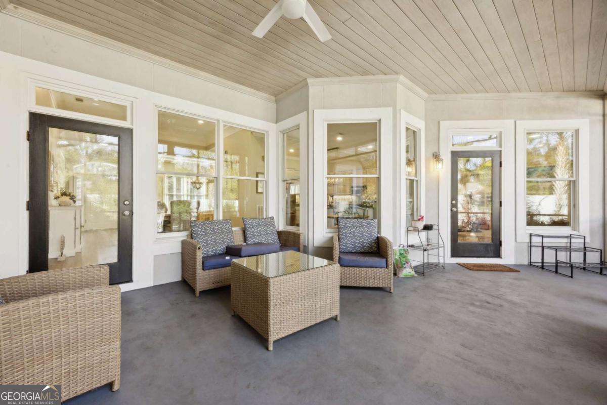 343 Major Wright Road St. Simons, GA 31522 - Photo 37 of 53 a living room with furniture and large windows
