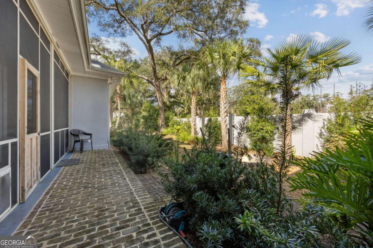 343 Major Wright Road St. Simons, GA 31522 - Photo 38 of 53 a view of a pathway both side of house