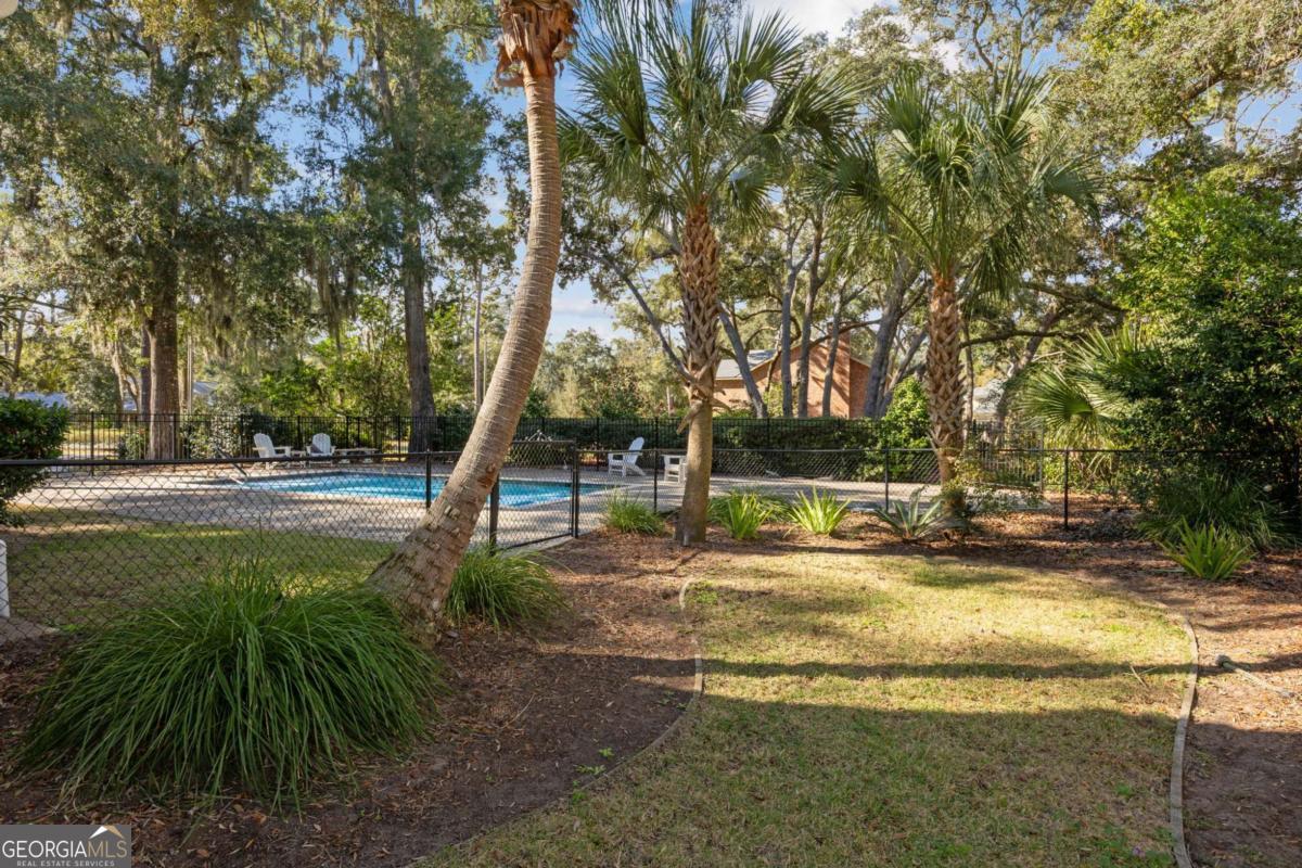 343 Major Wright Road St. Simons, GA 31522 - Photo 45 of 53 a view of a fountain in the middle of a yard