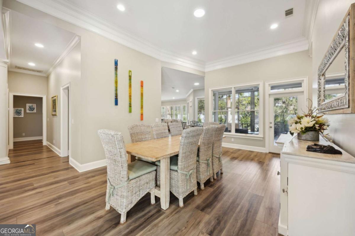 343 Major Wright Road St. Simons, GA 31522 - Photo 8 of 53 a view of a dining room with furniture window and wooden floor
