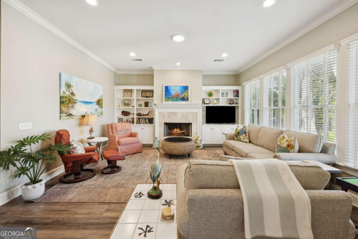 343 Major Wright Road St. Simons, GA 31522 - Photo 10 of 53 a living room with furniture fireplace and a large window