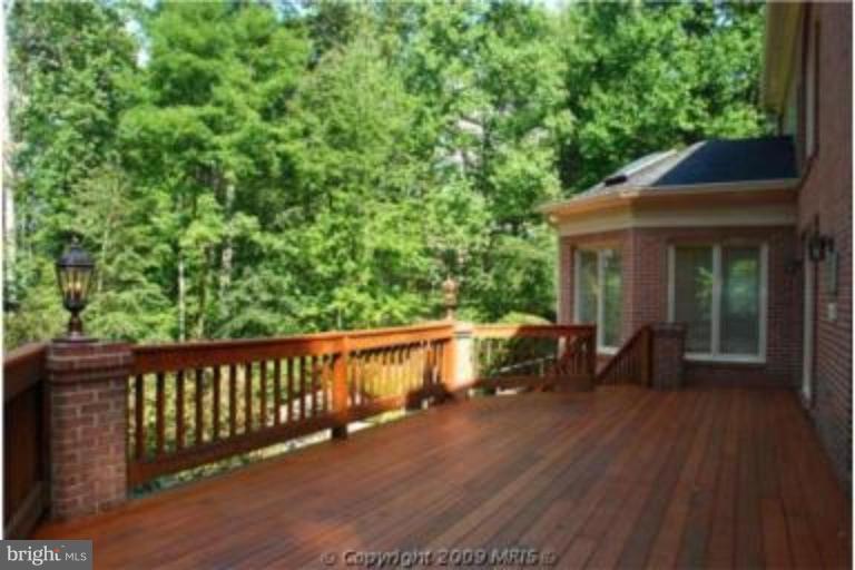 11008 South Glen Road Potomac, MD 20854 - Photo 7 of 12 a view of a wooden chairs and table in the balcony