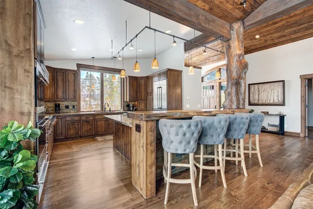 a large kitchen with a table and chairs in it