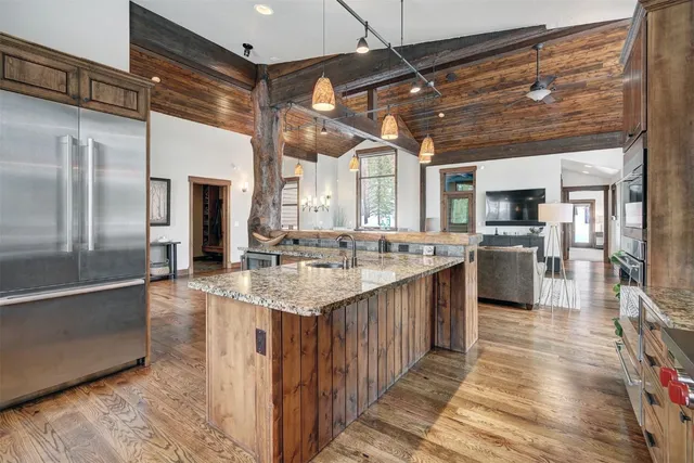 a kitchen with stainless steel appliances granite countertop a sink and cabinets