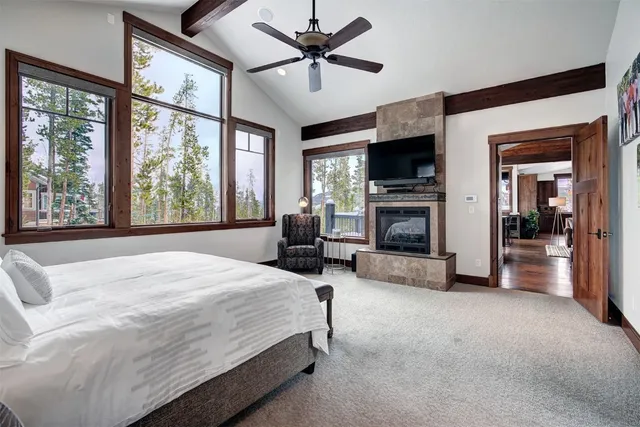 a spacious bedroom with a large bed and a fireplace