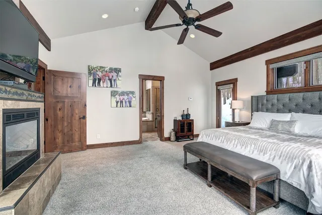 a spacious bedroom with a bed and a chandelier