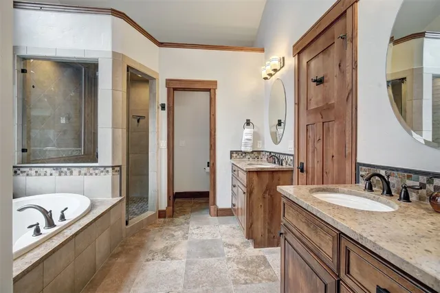 a bathroom with a granite countertop tub sink and mirror