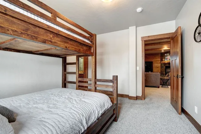 a bedroom with a bed and a large mirror