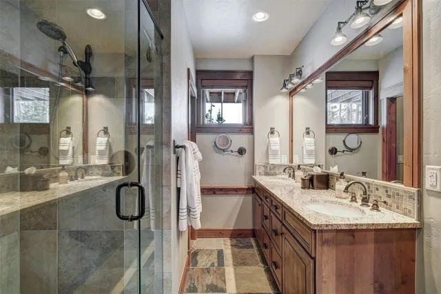a bathroom with a double vanity sink a and mirror