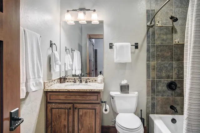 a bathroom with a sink vanity mirror and toilet
