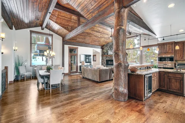 a living room with furniture a wooden floor and a sink