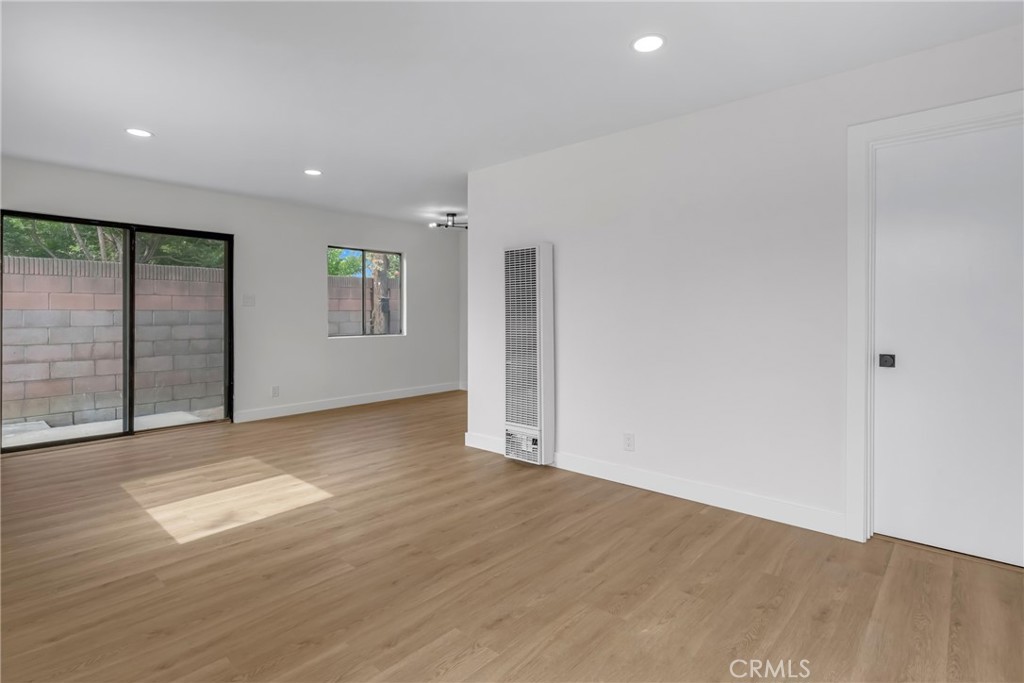 4713 Calada Avenue Pico Rivera, CA 90660 - Photo 20 of 24 an empty room with wooden floor and windows